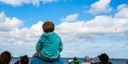 Kid watching the Torbay Airshow in Torquay Devon